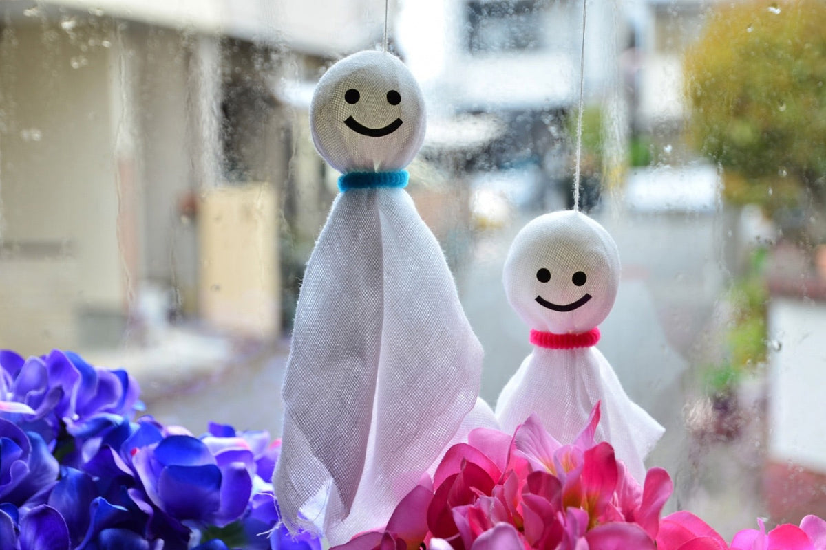 Teru Teru Bozu doll with hydrangeas during Japan’s rainy season