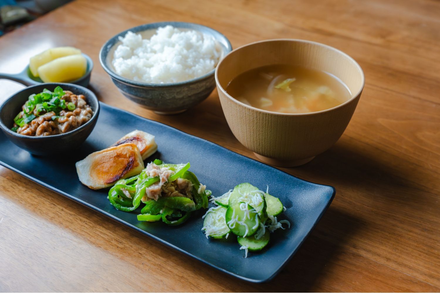 Traditional Japanese breakfast with rice, miso soup, spinach ohitashi and natto.